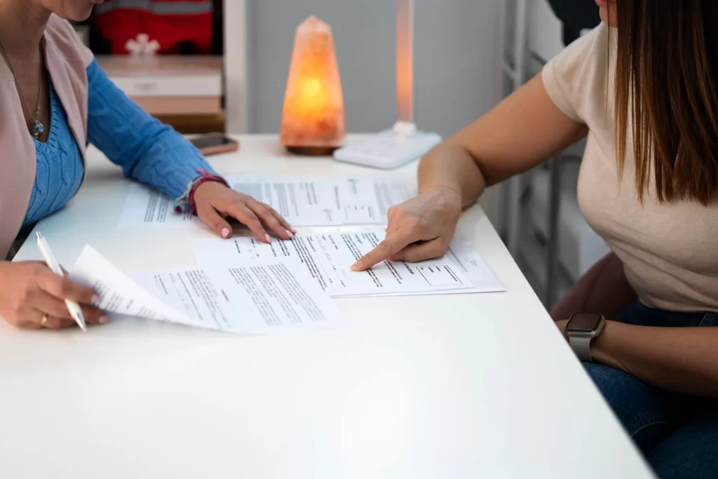 Two people reviewing documents together during a follow-up consultation.